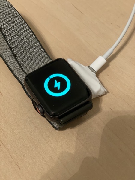 Charging puck charging an Apple Watch